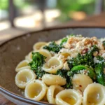 A plate of orecchiette pasta served with broccoli rabe and garlic.